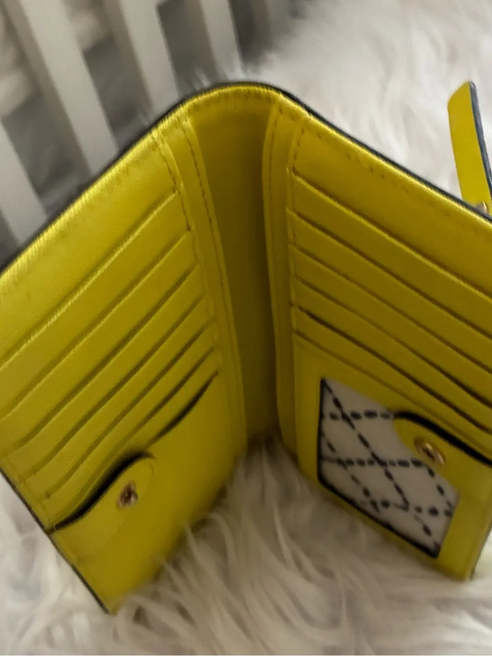Lime green Kate Spade New York slim bifold wallet features multiple card slots